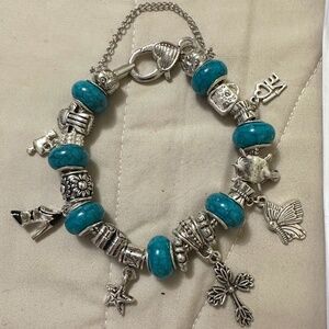 Handmade – NWOT – 925 silver plated charm bracelet. Teal beads. Variety charms.